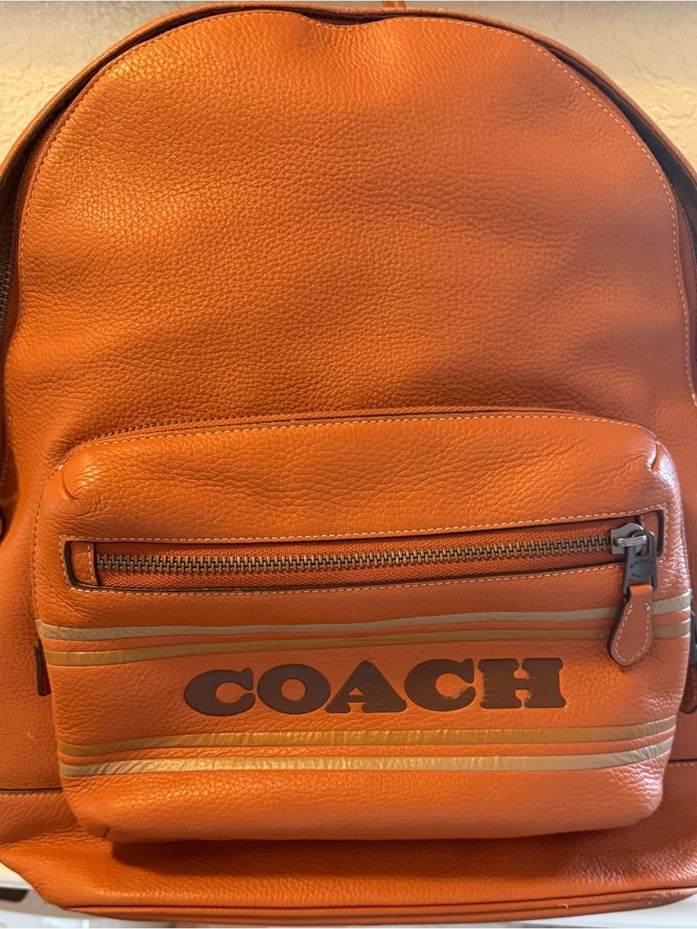 COACH Orange Pebbled Leather Men's Backpack with Front Logo Pocket